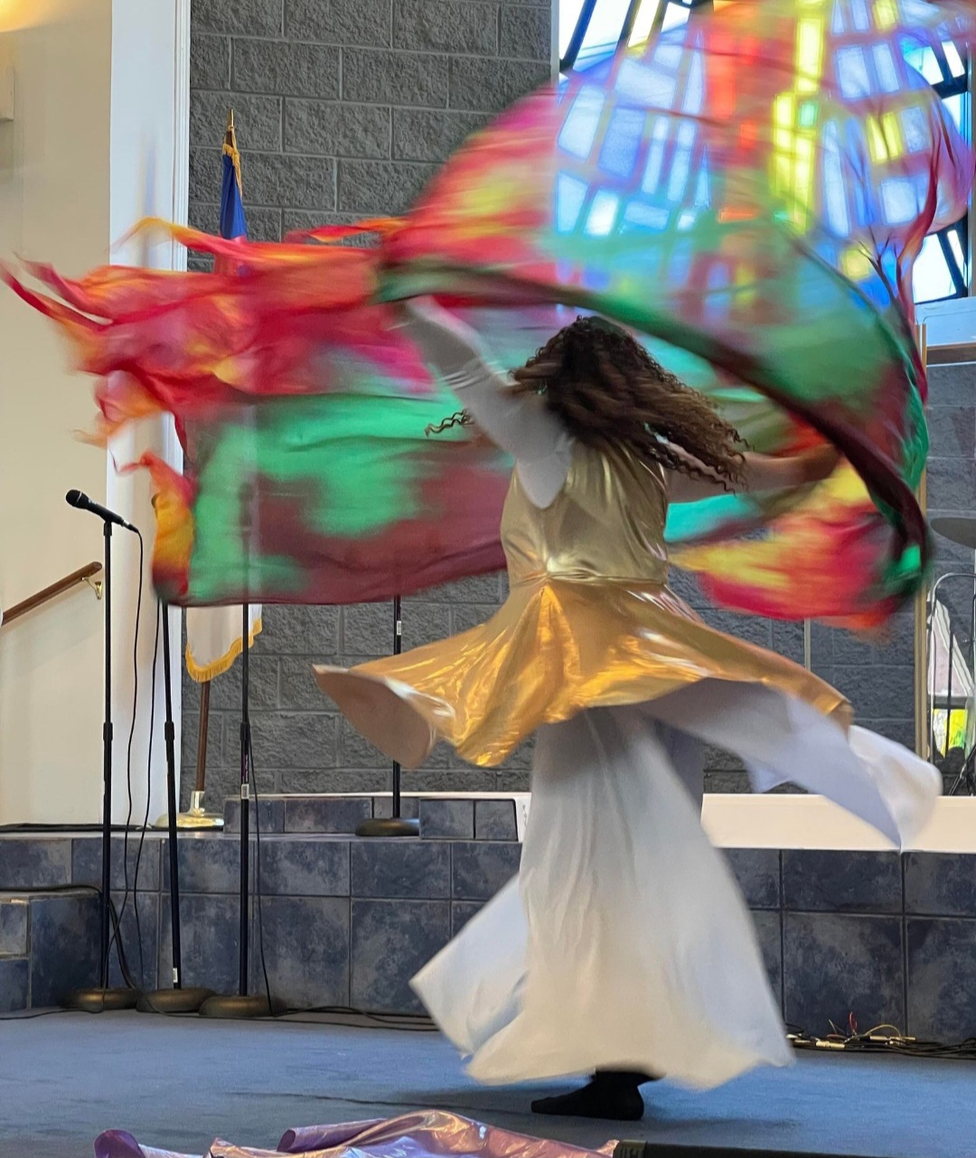 Talina Richardson, Founder & Instructor — worshiping with colorful flags in motion