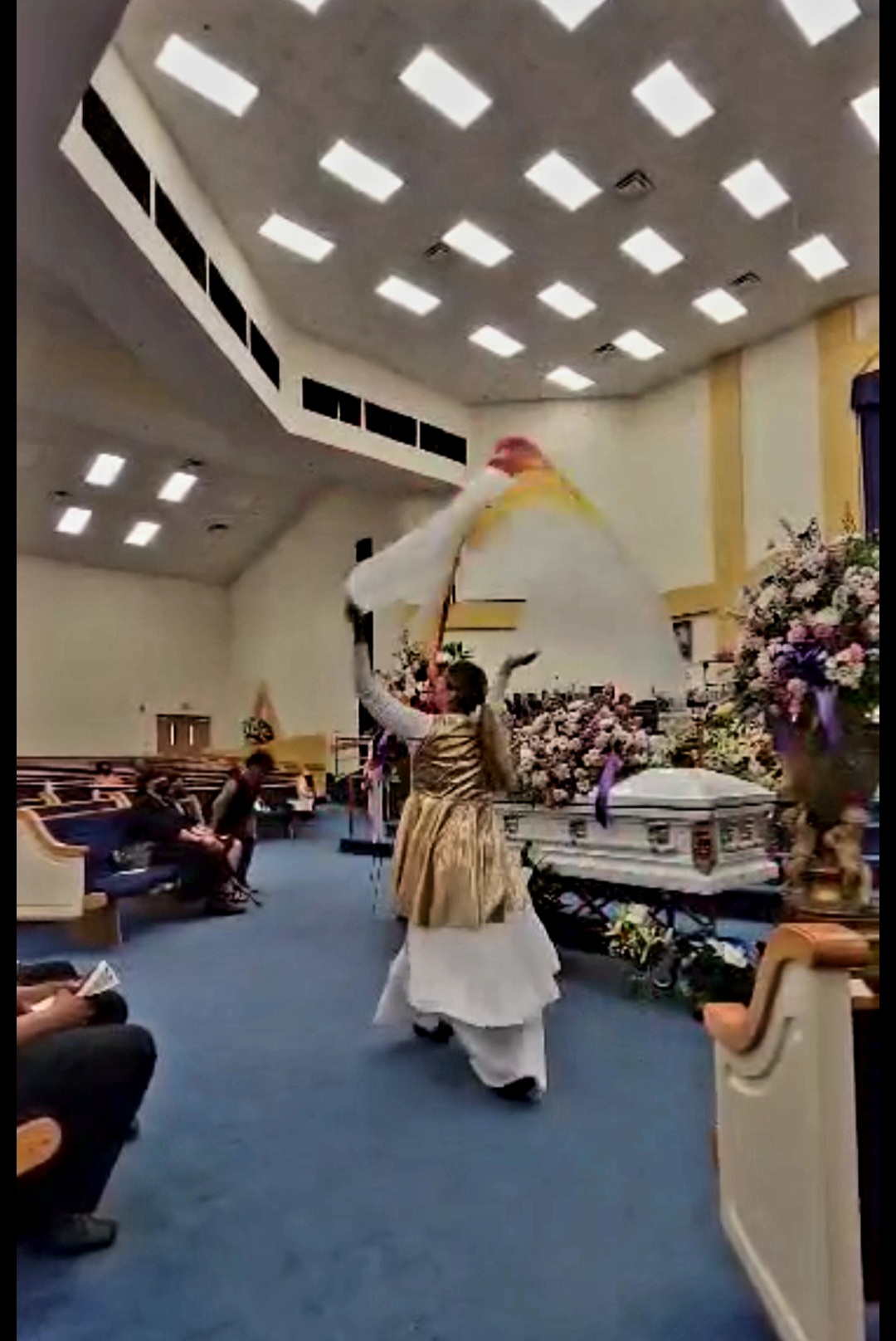 Worshipper ministering with a large silk in the sanctuary