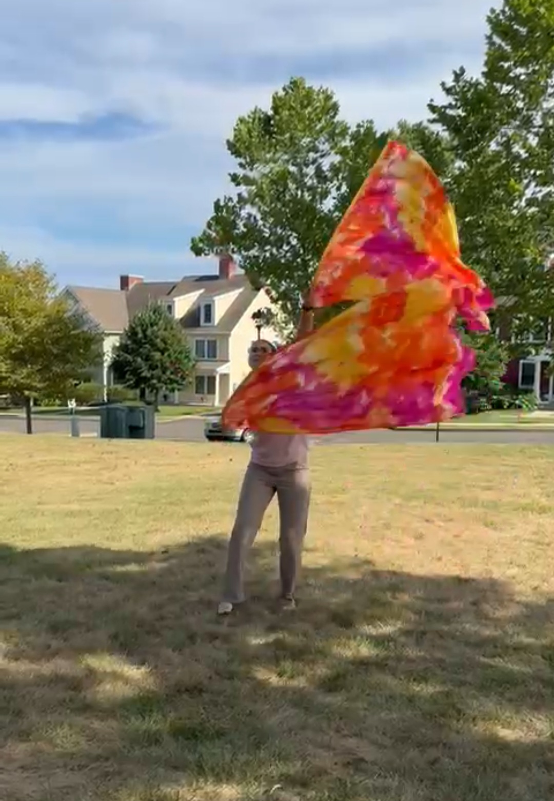 Worshipper flagging with a fire-colored silk in an open field